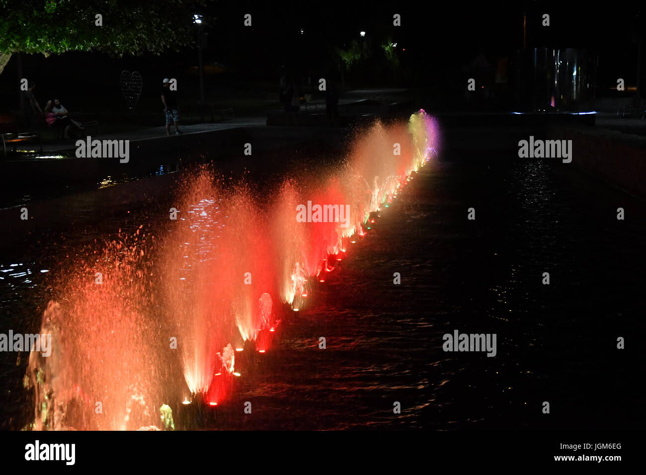colored water fountain in the city park in the night Stock Photo - Alamy