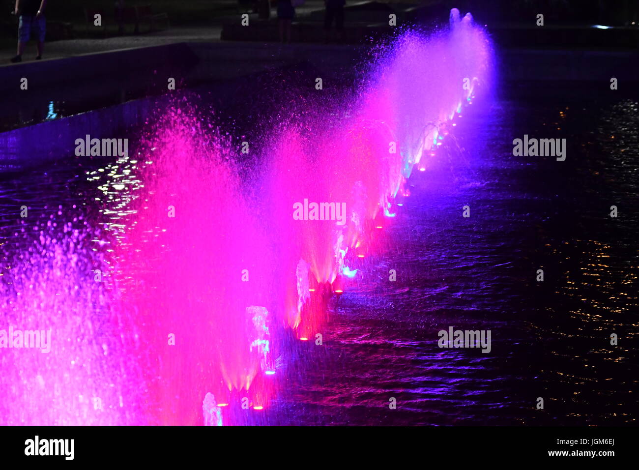 colored water fountain in the city park in the night Stock Photo - Alamy