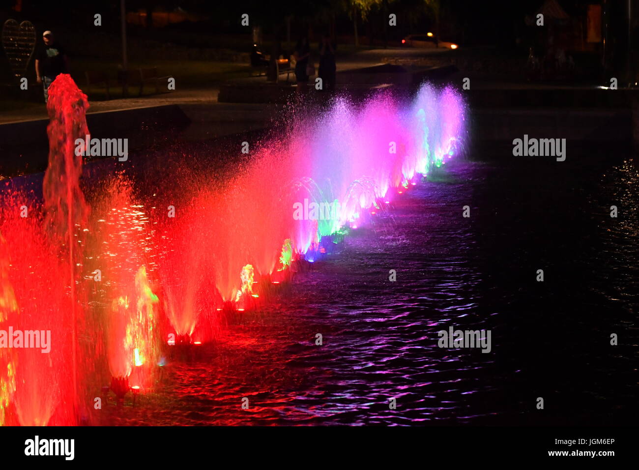 colored water fountain in the city park in the night Stock Photo - Alamy