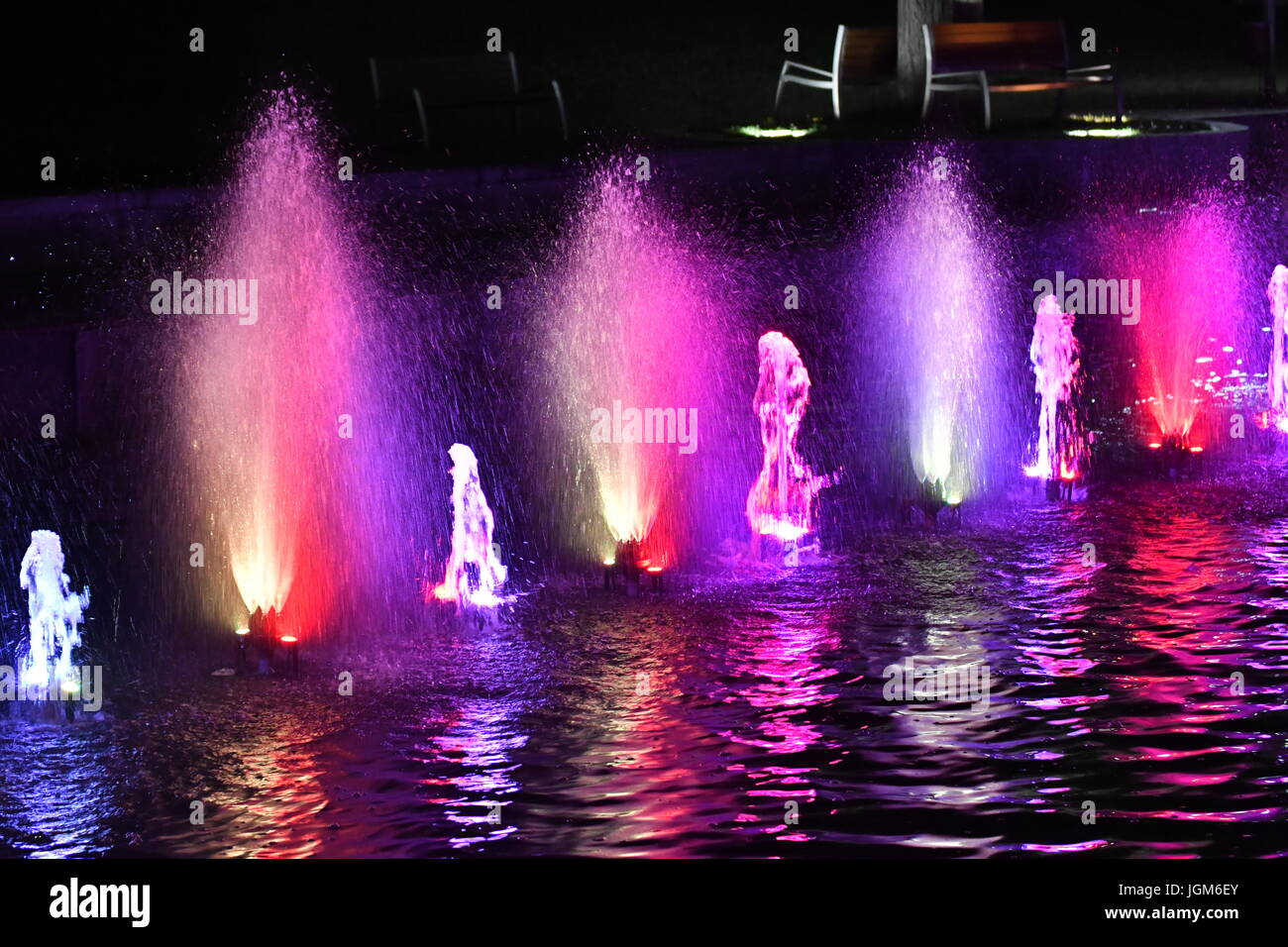 colored water fountain in the city park in the night Stock Photo - Alamy