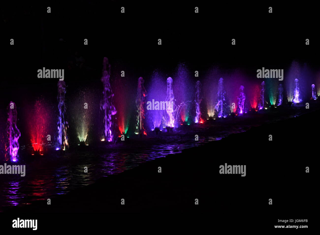 colored water fountain in the city park in the night Stock Photo - Alamy