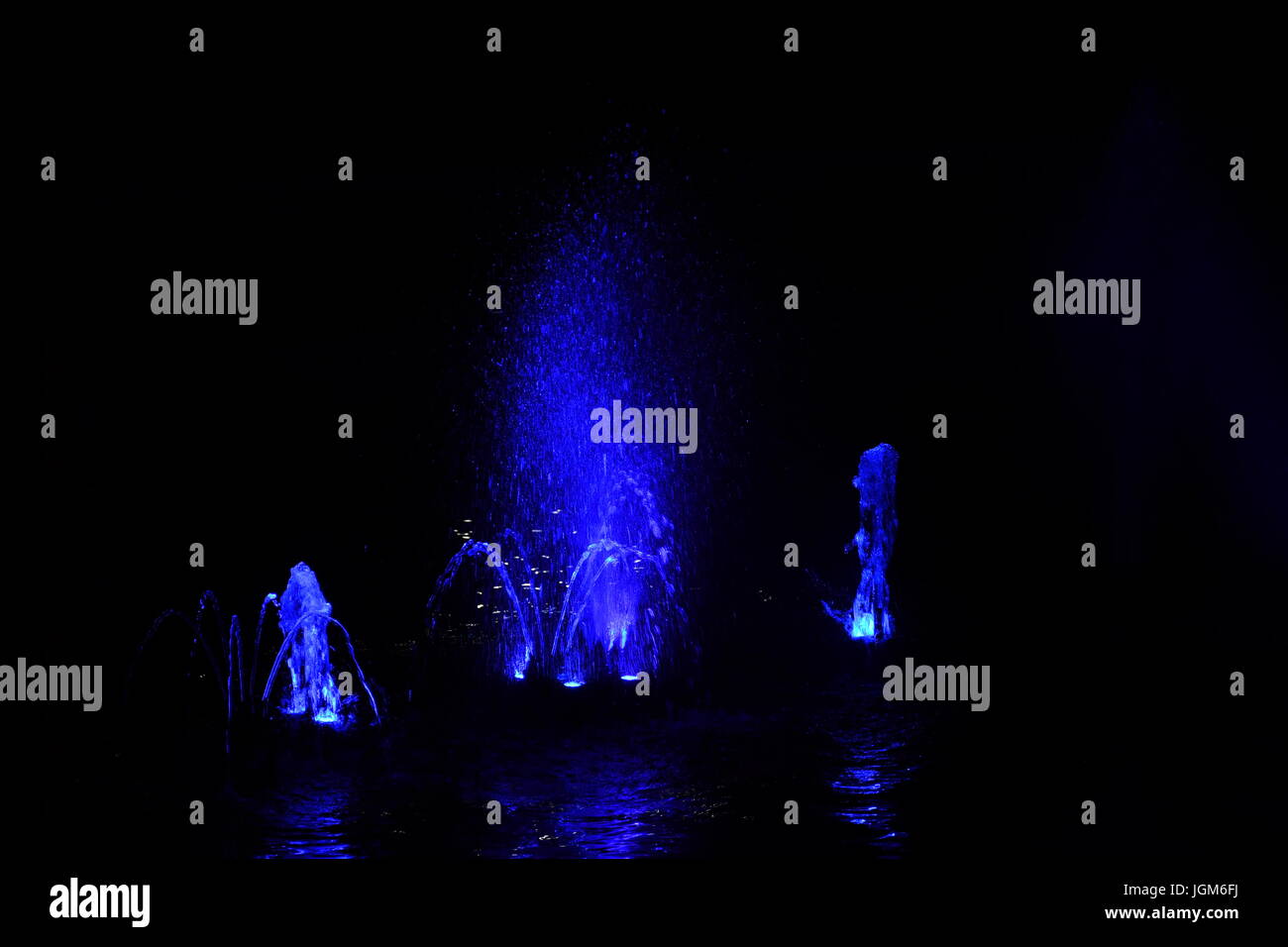 colored water fountain in the city park in the night Stock Photo - Alamy