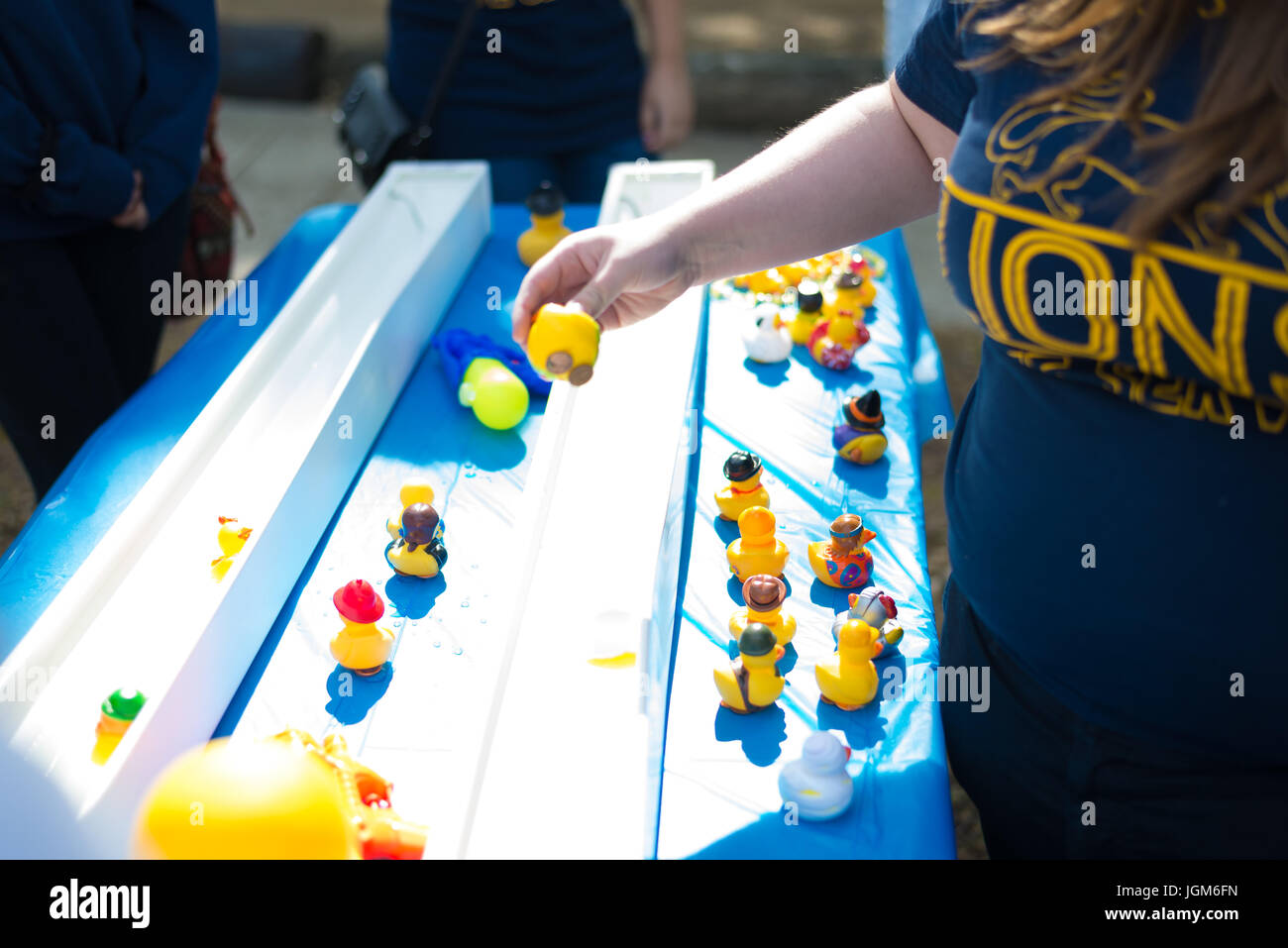 Rubber duck water gun shooting game at volunteer charity festival Stock Photo
