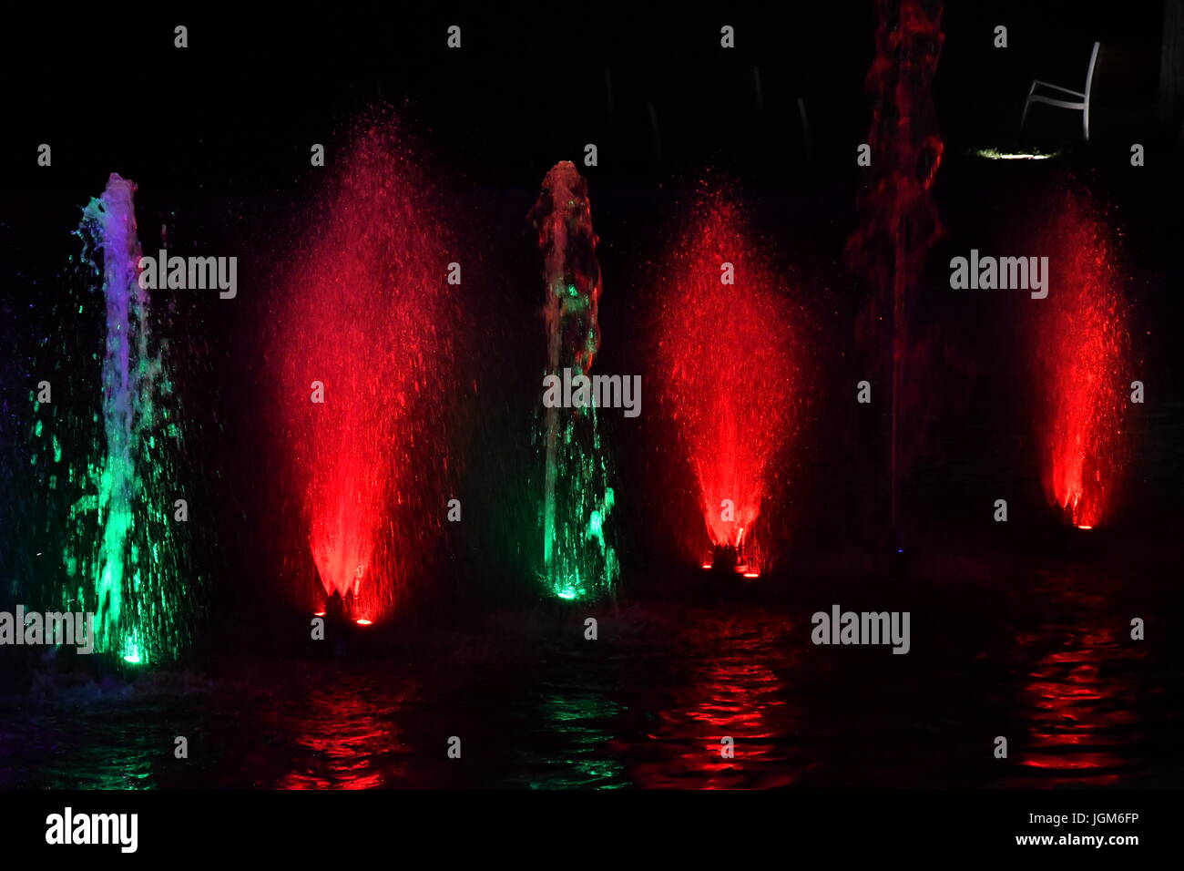 colored water fountain in the city park in the night Stock Photo - Alamy