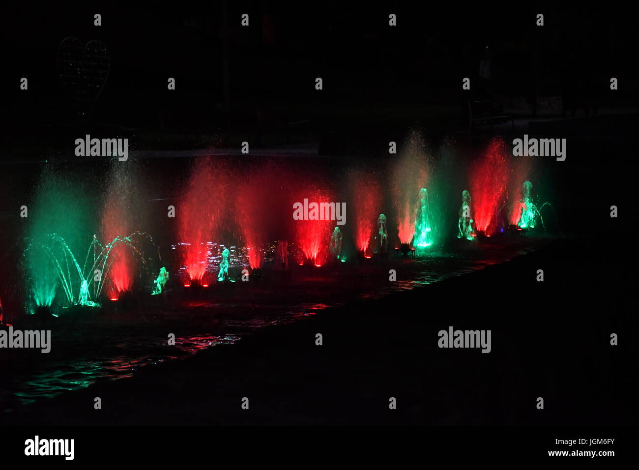 colored water fountain in the city park in the night Stock Photo - Alamy