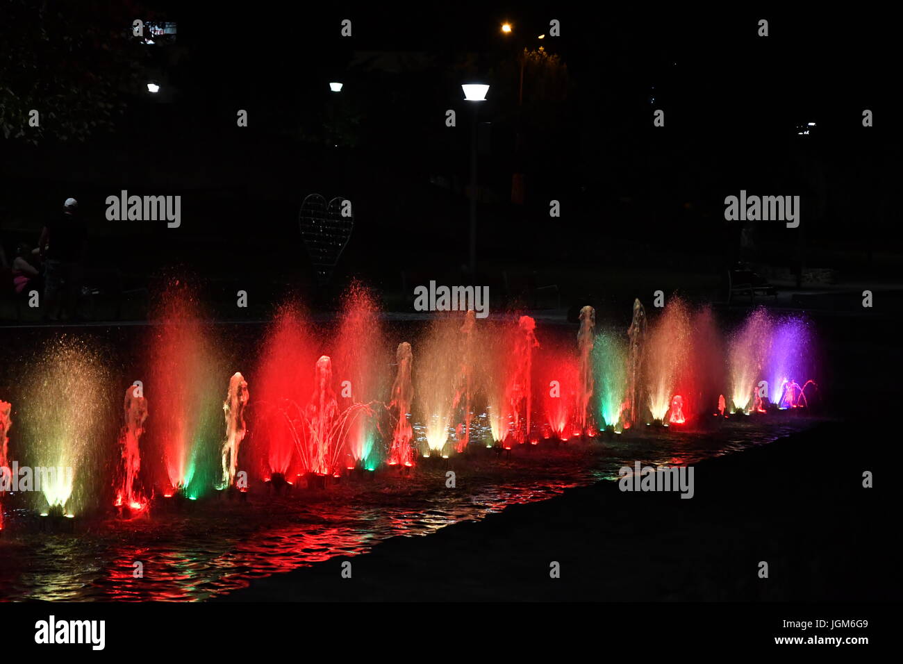 colored water fountain in the city park in the night Stock Photo - Alamy
