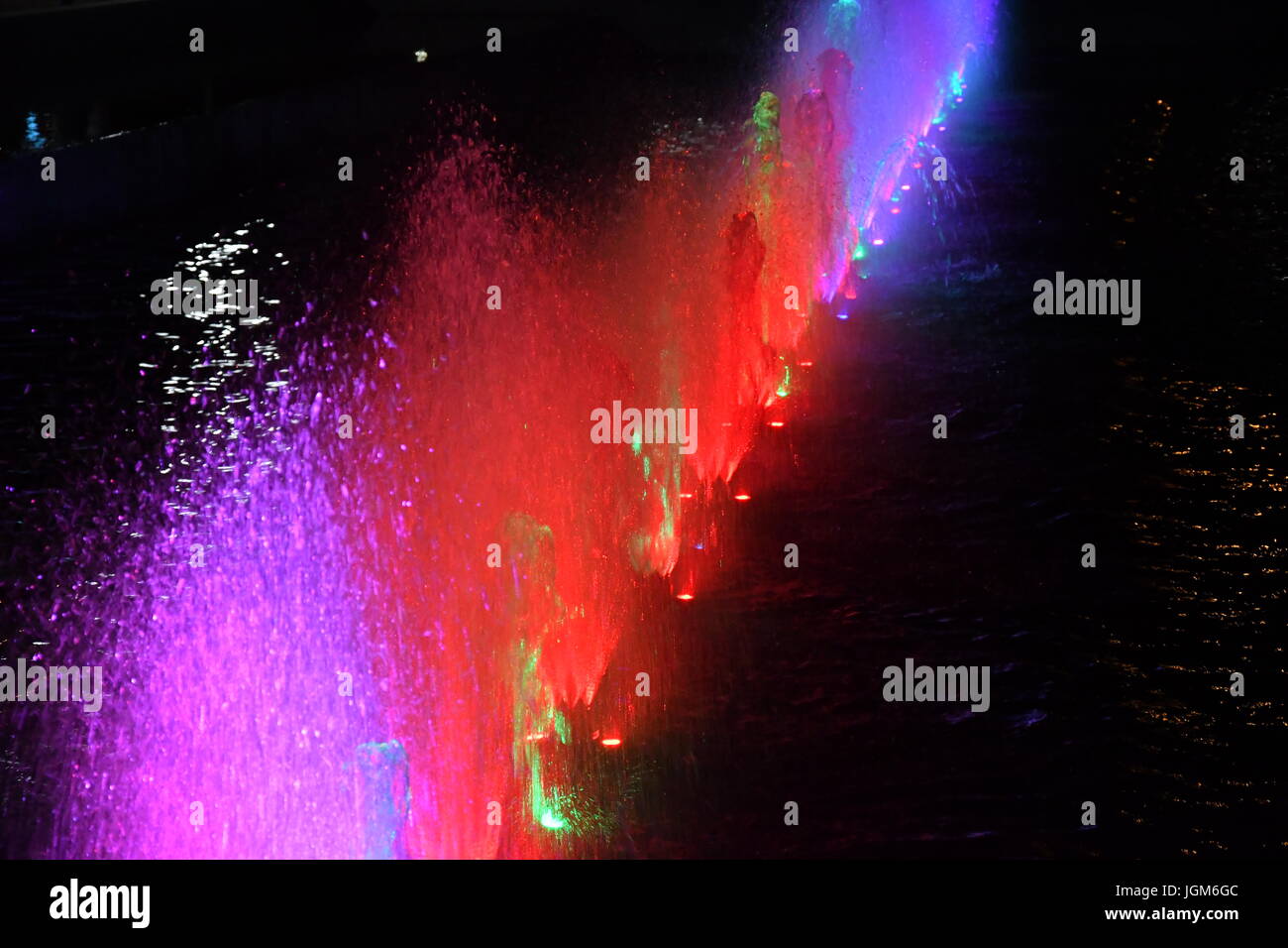 colored water fountain in the city park in the night Stock Photo - Alamy