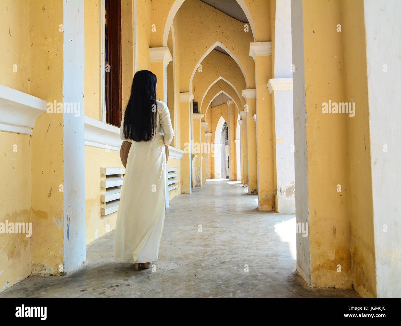 Asian woman standing at the old church in Mekong Delta, Vietnam. Stock Photo