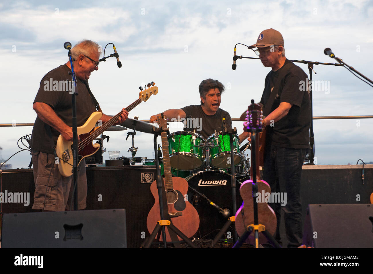 Percussionist Enrique González and guitarists Conrad Lozano and Louie Pérez playing with the Los Lobos band during a River and Blues concert in Batter Stock Photo