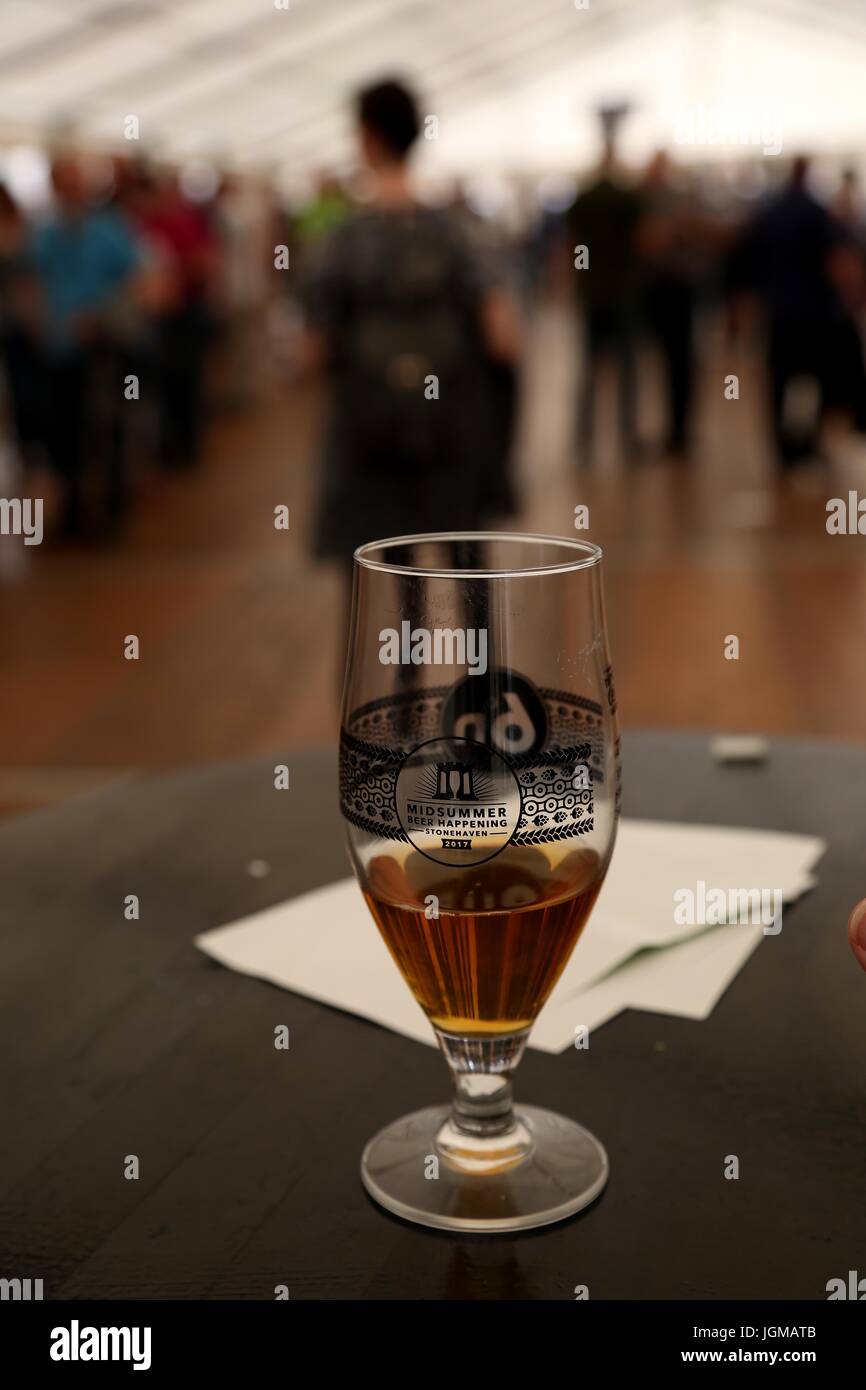 Half full glass of beer on the table at the Stonehaven Beer Festival