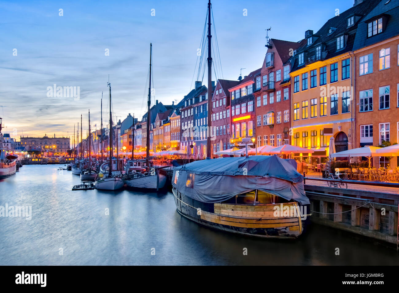 Nyhavn with its picturesque harbor with old sailing ships and colorful facades of old houses in Copenhagen, Denmark. Stock Photo