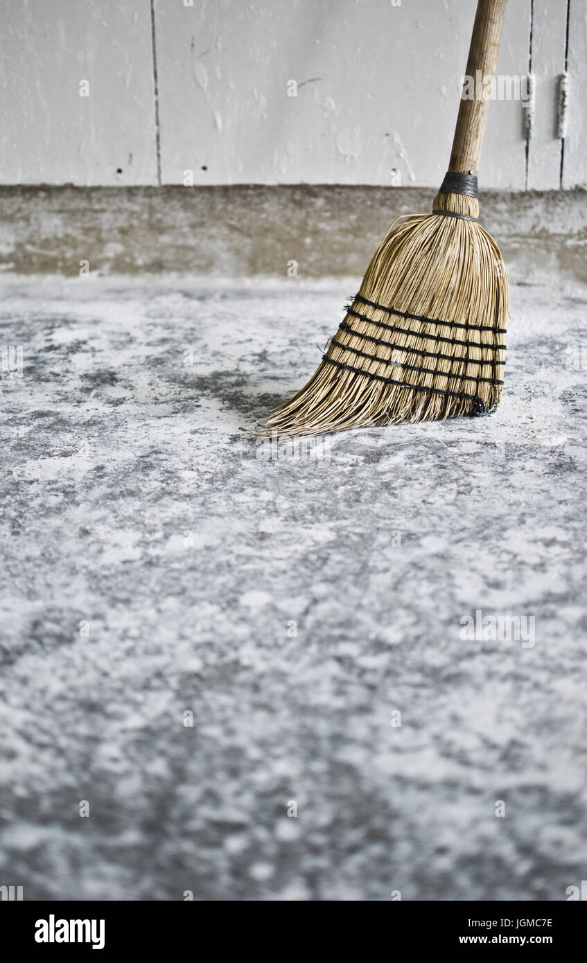 Classic straw broom sweeping a concrete floor Stock Photo Alamy