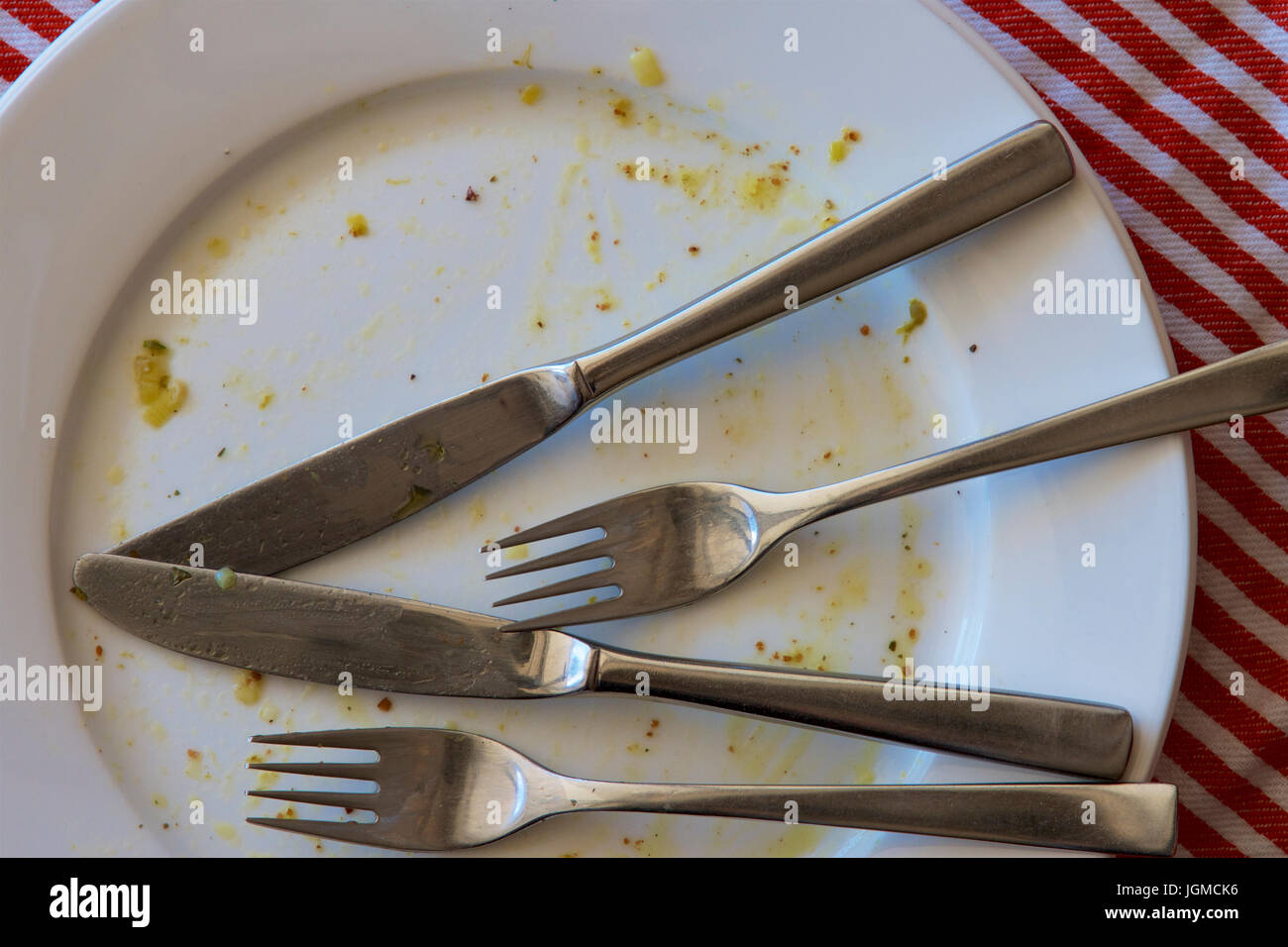Dirty plates and cutlery after a meal. Stock Photo