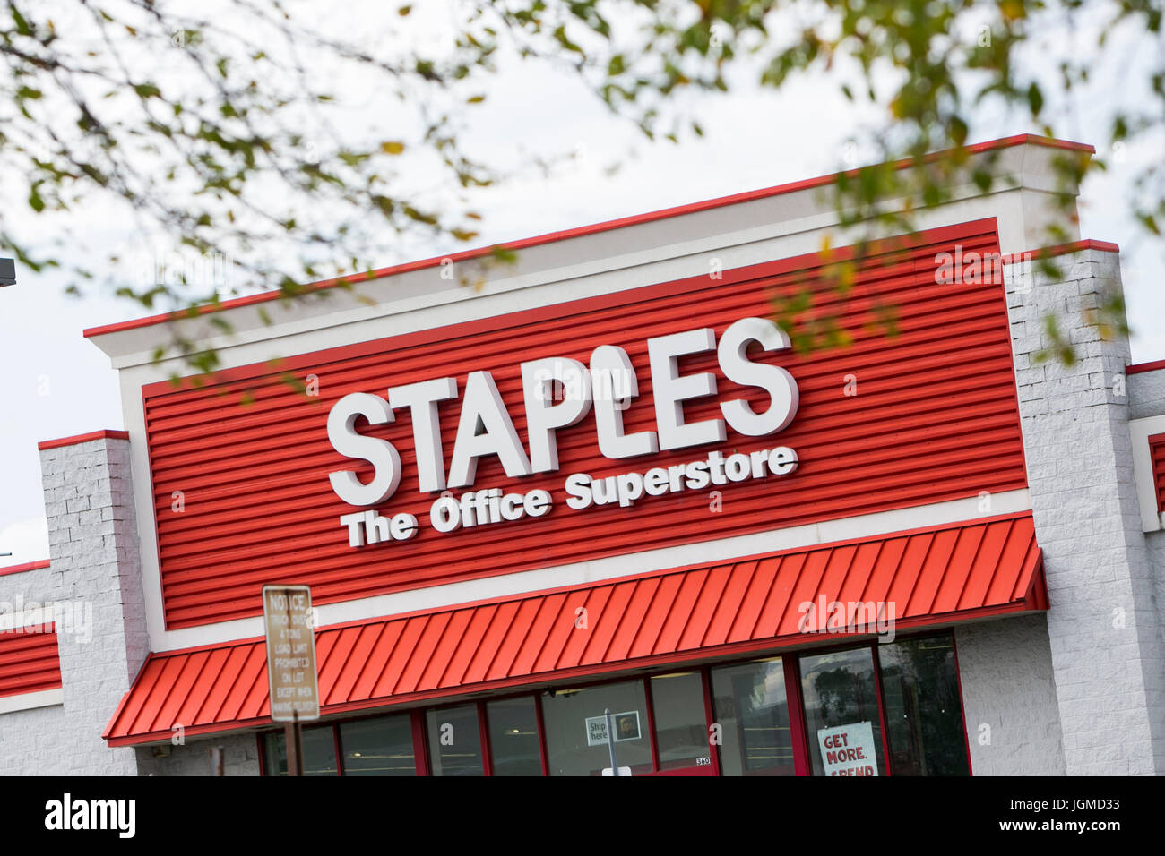 A logo sign outside of a Staples office supply retail store in Franklin