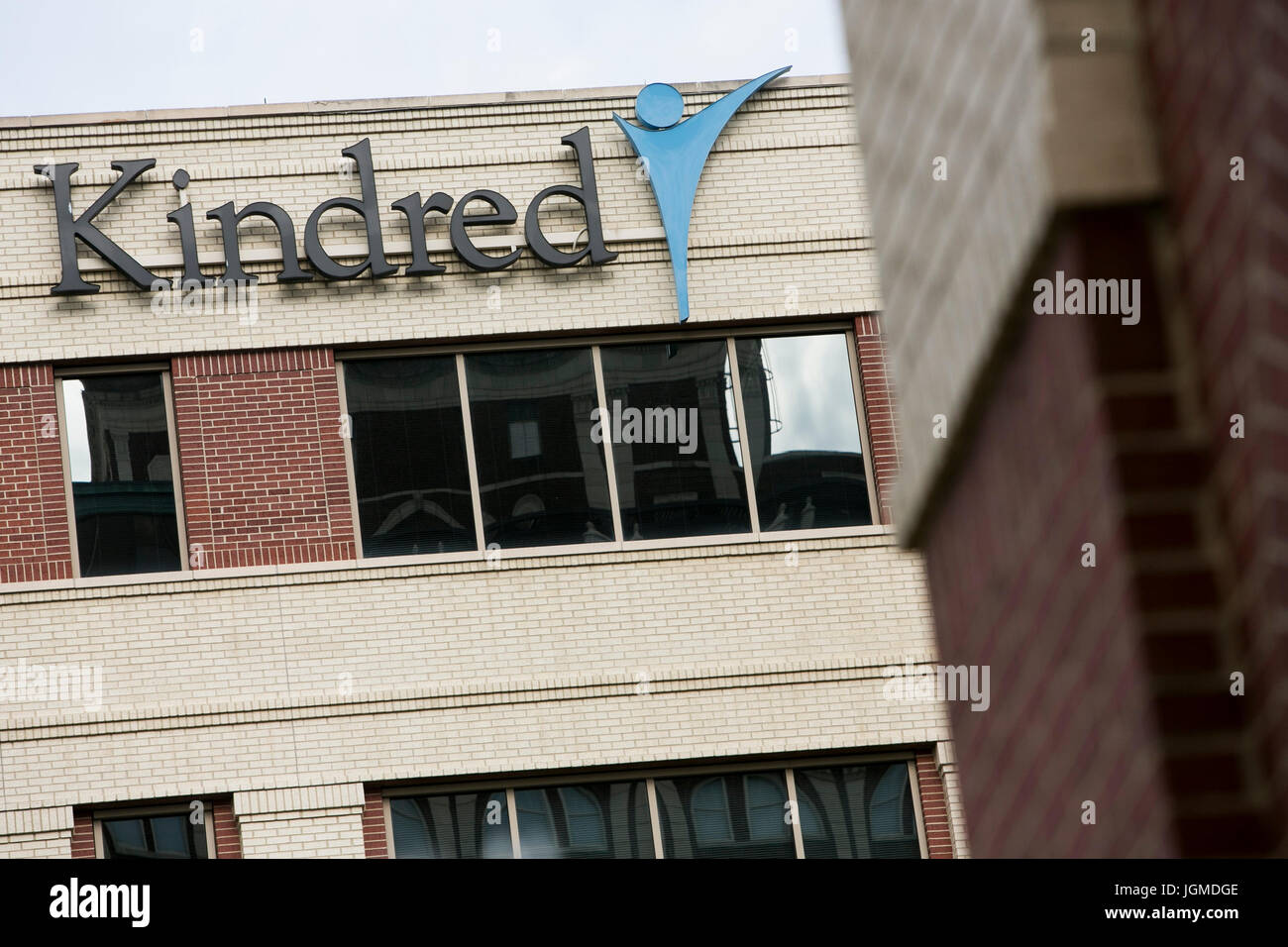 A logo sign outside of the headquarters of Kindred Healthcare in