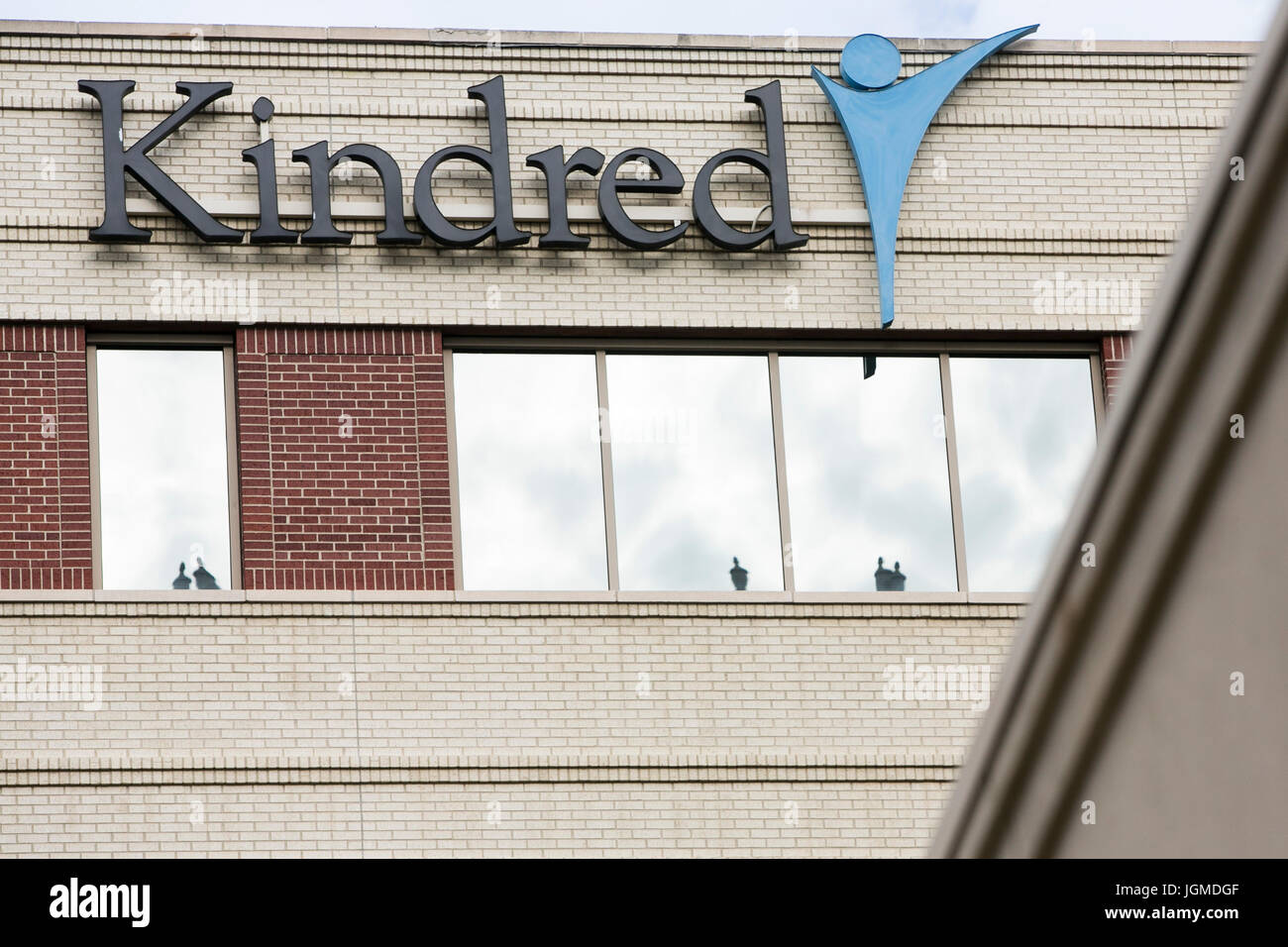 A logo sign outside of the headquarters of Kindred Healthcare in