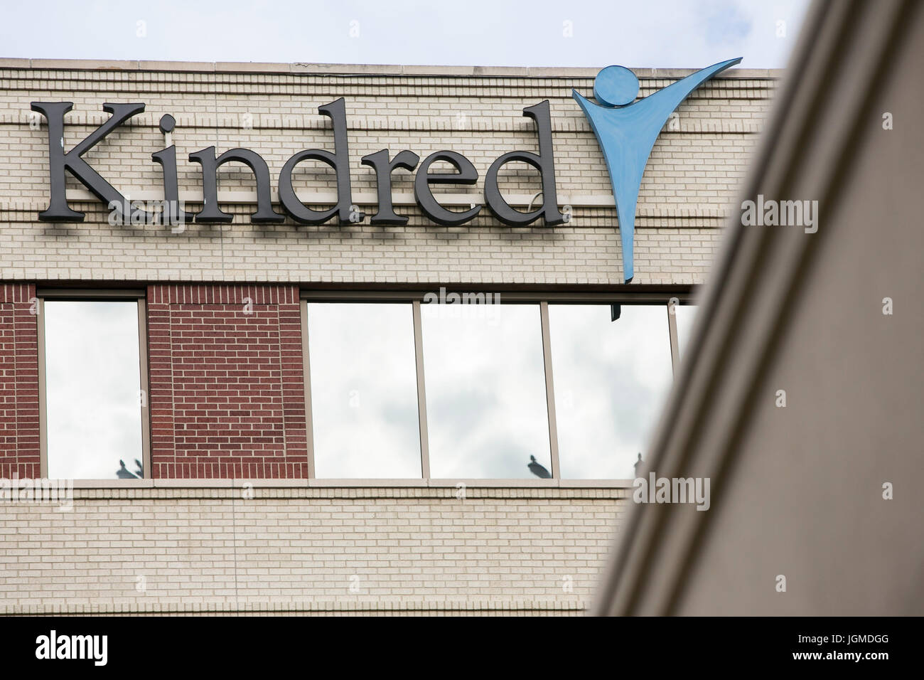 A logo sign outside of the headquarters of Kindred Healthcare in