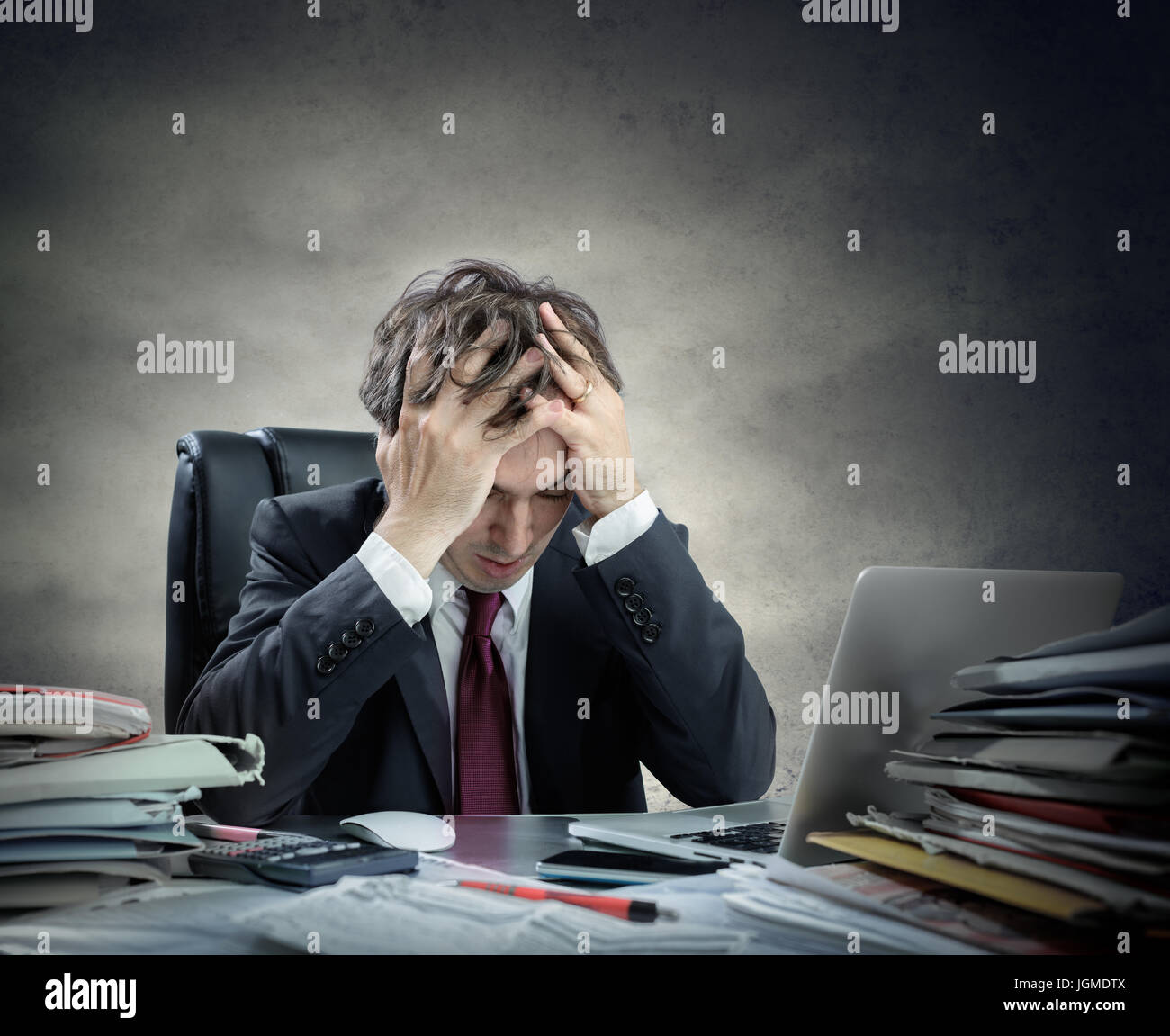 Frustrated Businessman Sitting In Office Stock Photo