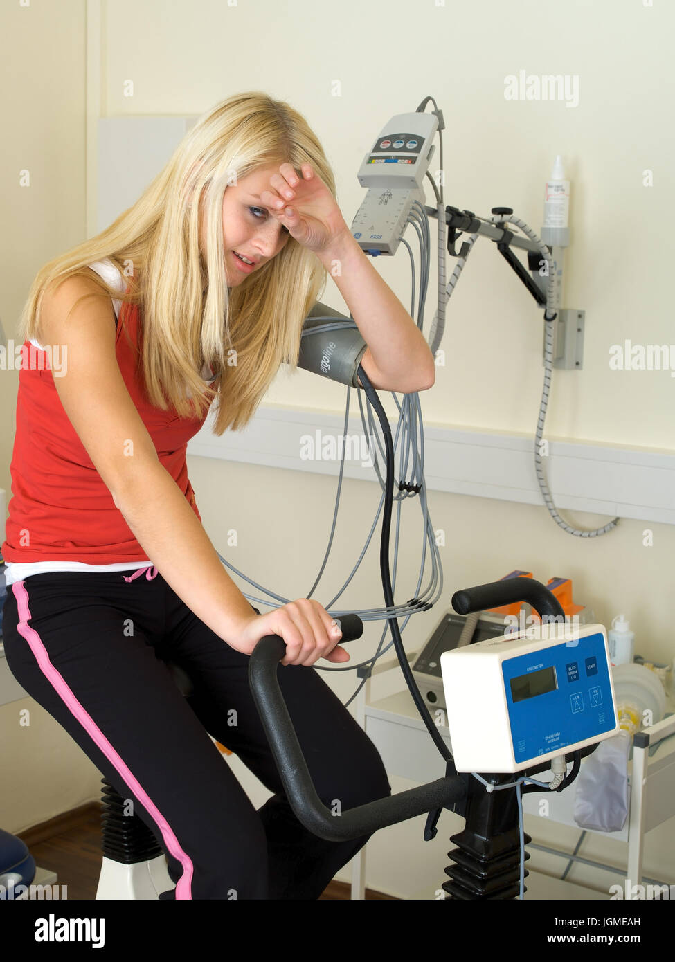 Young woman carries out an ergometer test in the medical practise - Young woman on an ergometer in the surgery, Junge Frau führt einen Ergometer-Test Stock Photo