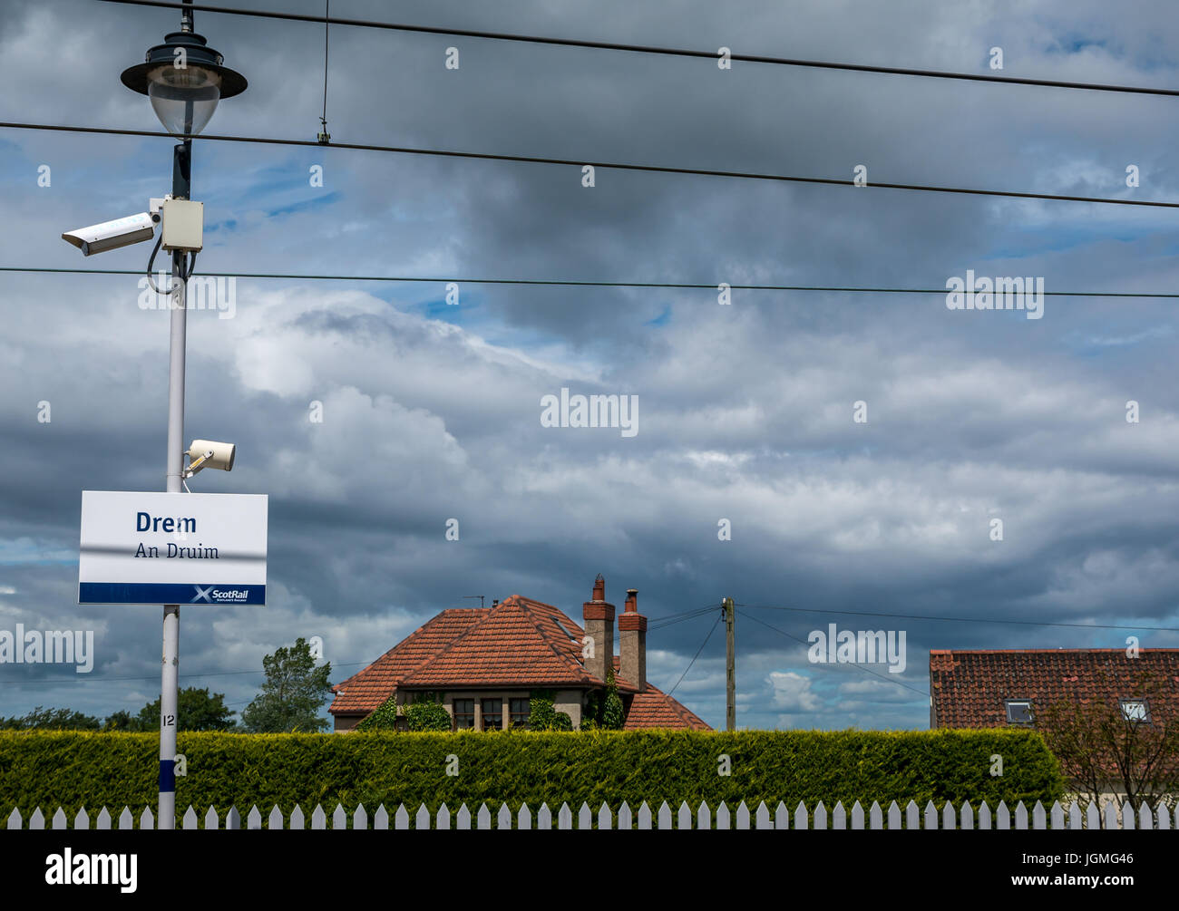 Drem train station platform with Gaelic name sign, An Druim, and CCTV camera, East Lothian, Scotland leaves, UK Stock Photo