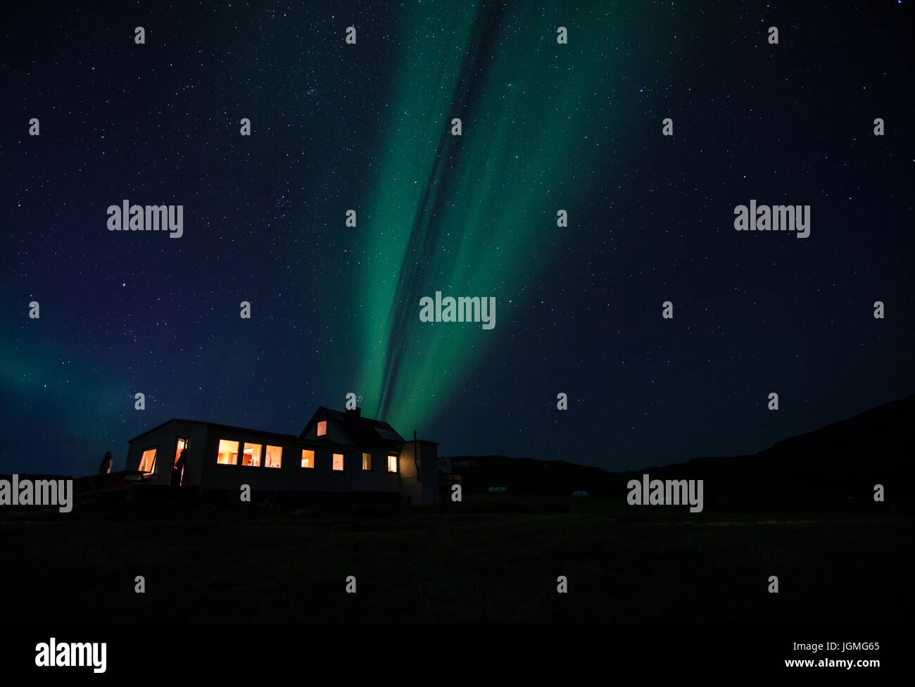 Northern lights at night over a farm house, Greenland Stock Photo