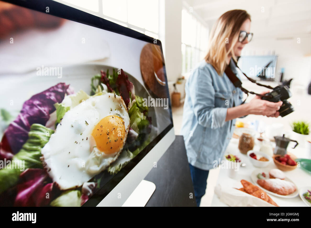 Food stylist photographing served table in photostudio Stock Photo