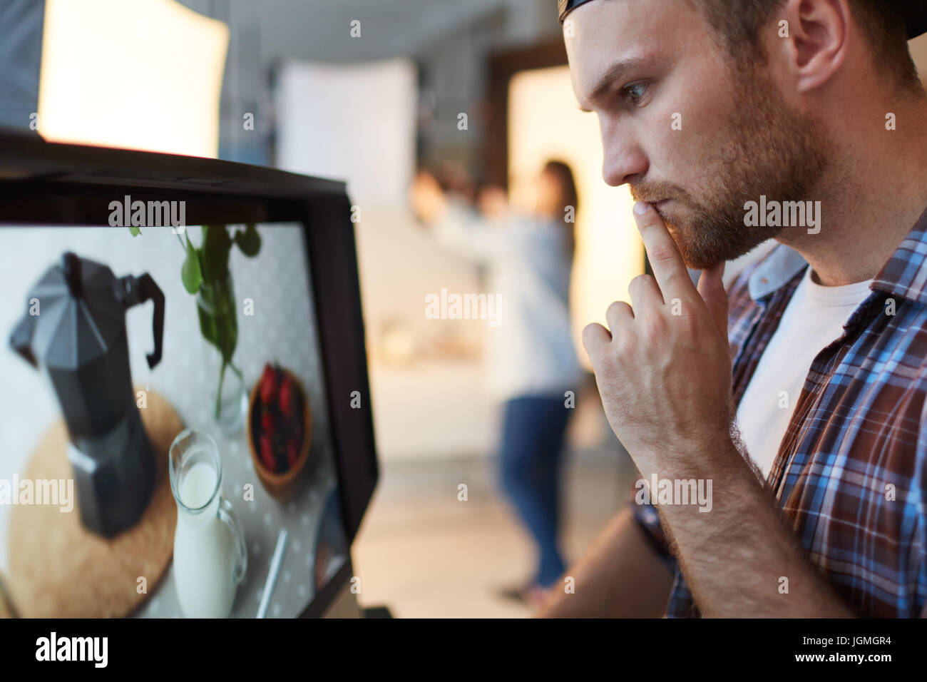 Pensive food-blogger in front of monitor Stock Photo