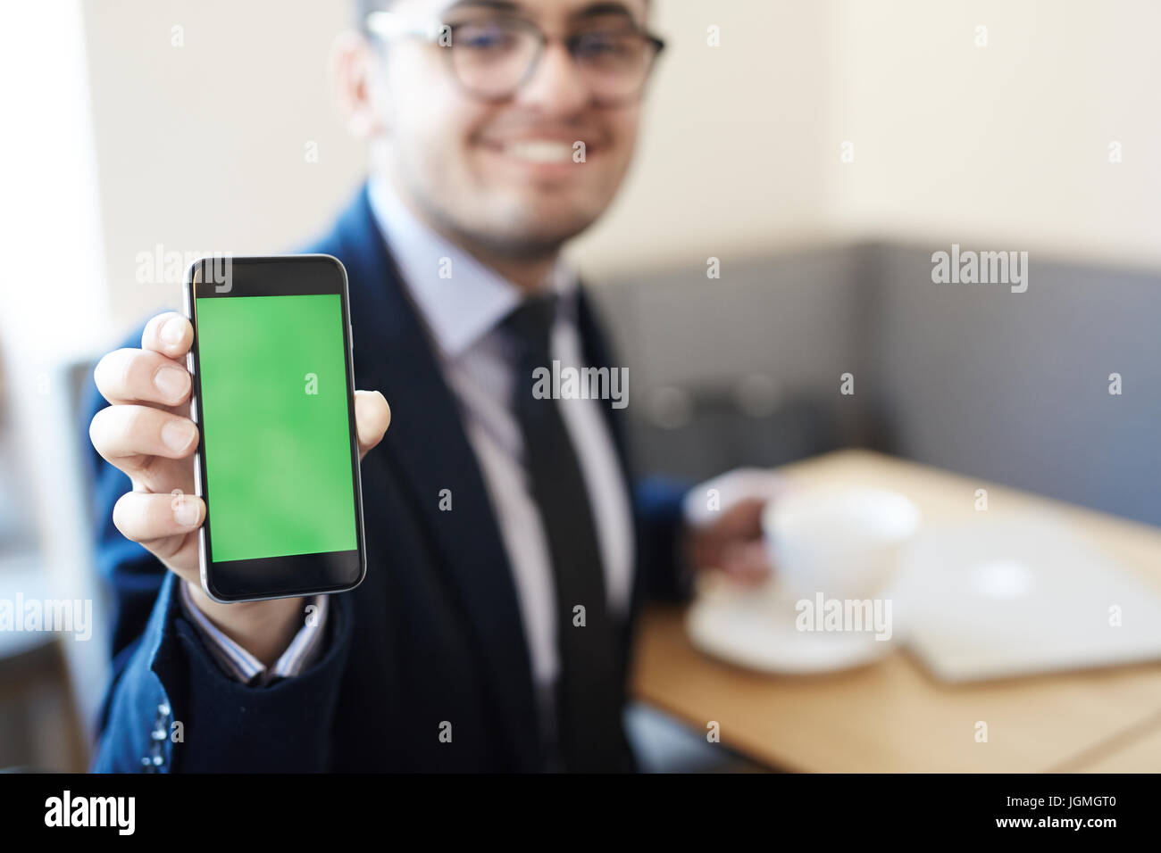 Modern businessman showing touchscreen of gadget Stock Photo - Alamy