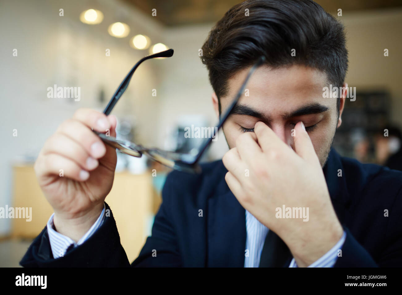 Stressed or tired man with eyeglasses Stock Photo