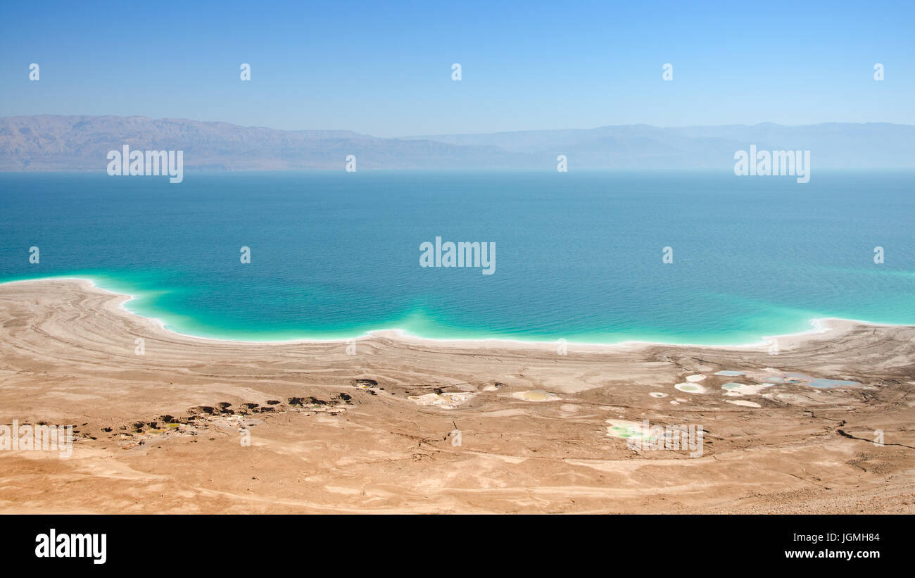 Aerial panoramic landscape of Dead Sea lake with salt water and curative mud shores beaches Stock Photo