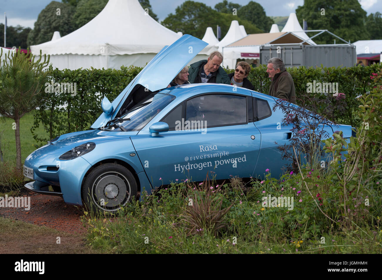Riversimple 'Rasa' hydrogen powered eco car viewed by people in show garden - RHS Chatsworth Flower Show, Chatsworth House, Derbyshire, England, UK. Stock Photo