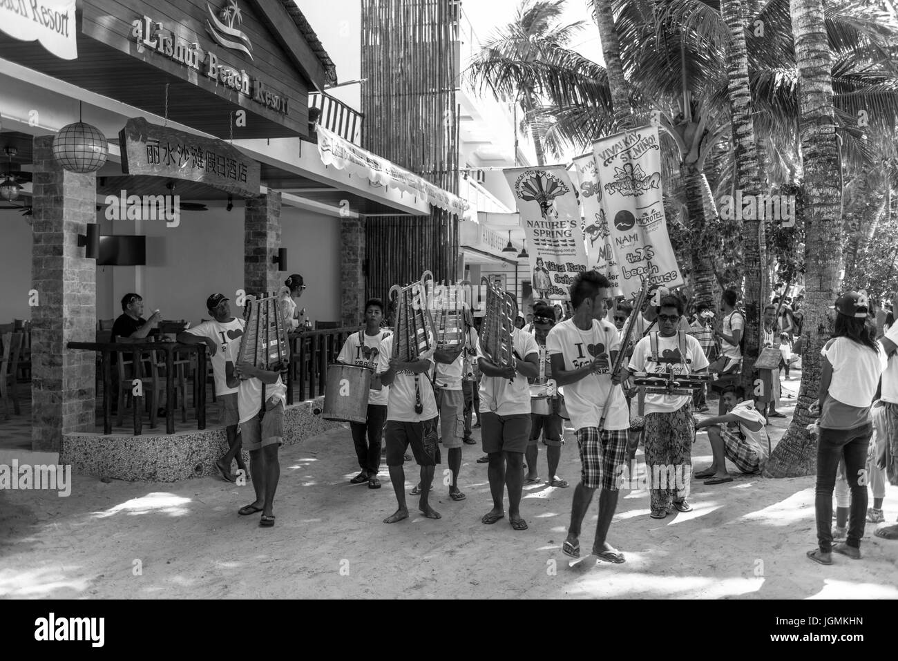 Black and white picture of people celebrating Ati-Atihan Festival with dance and music at White Beach. Stock Photo