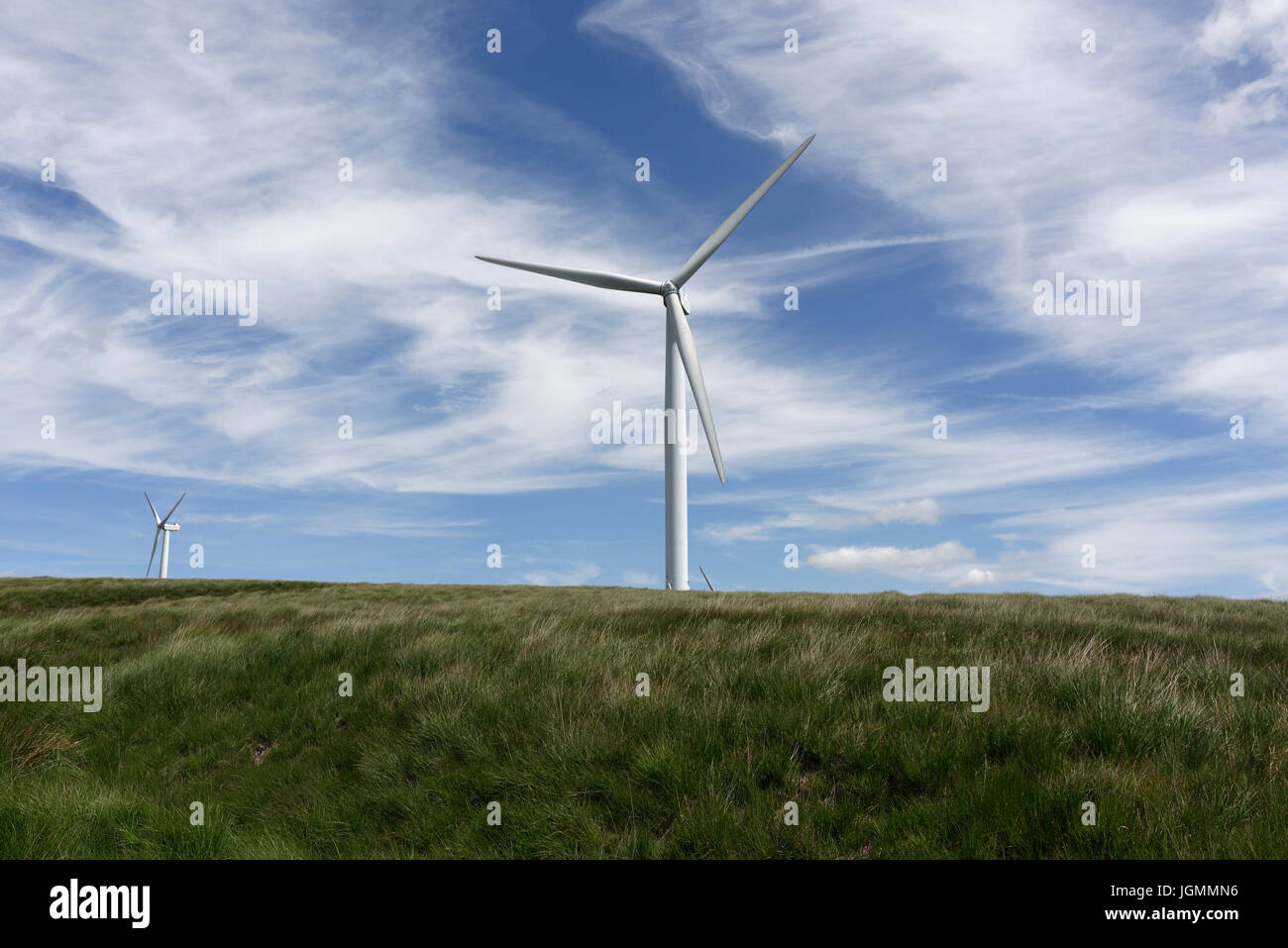 Wind turbine a source of renewable and sustainable energy at scout moor wind farm, with sky filled with wispy cirrus clouds above landscape uk Stock Photo
