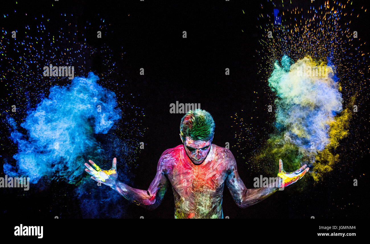Man throwing up glowing powder Stock Photo Alamy