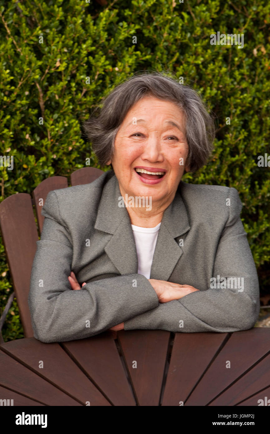 Portrait of happy Asian woman smiling outside. Stock Photo