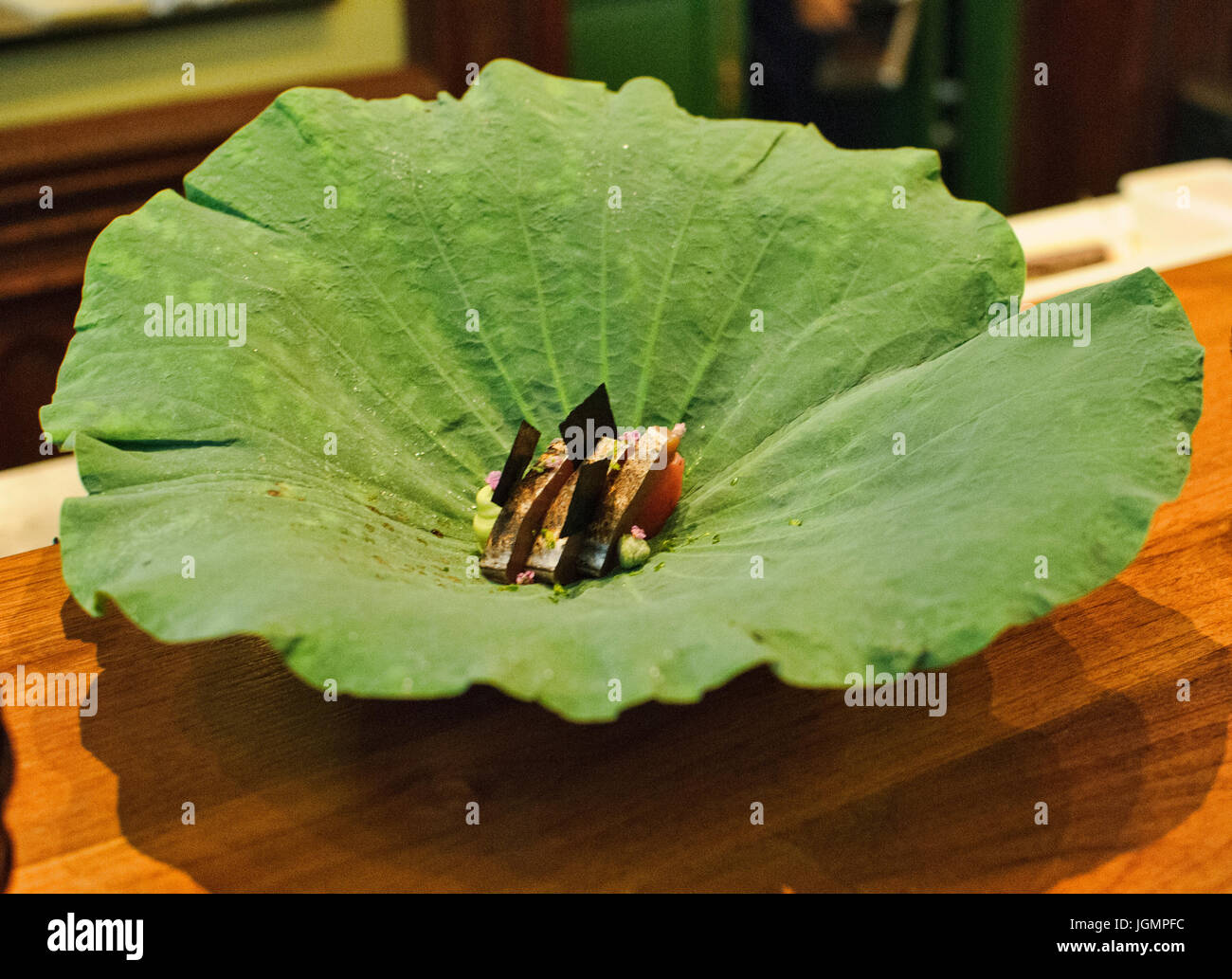 Katsuo tuna on a lotus leaf at an elegant restaurant, Bangkok, Thailand Stock Photo