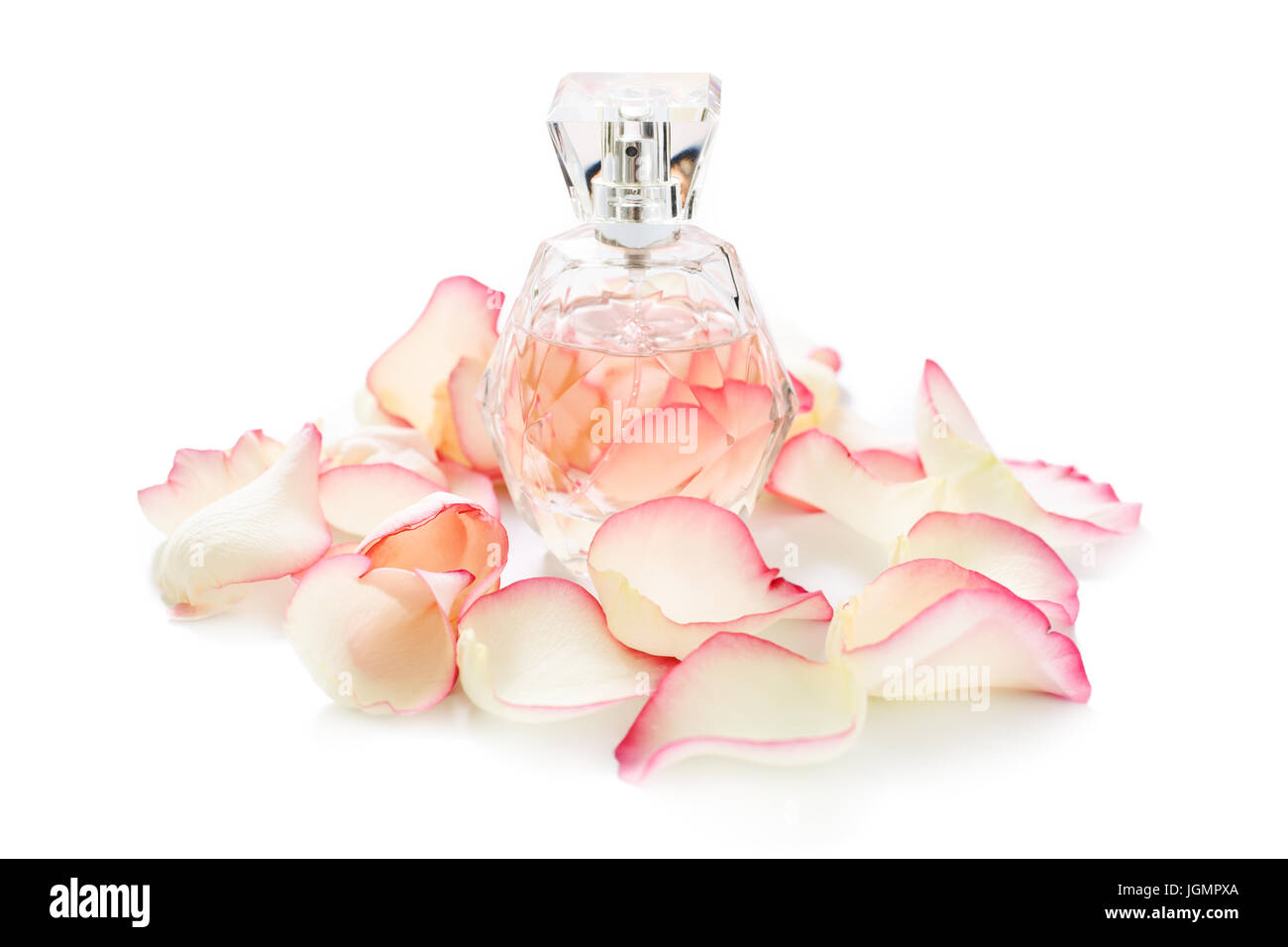 Perfume bottle with flower petals on light background. Perfumery