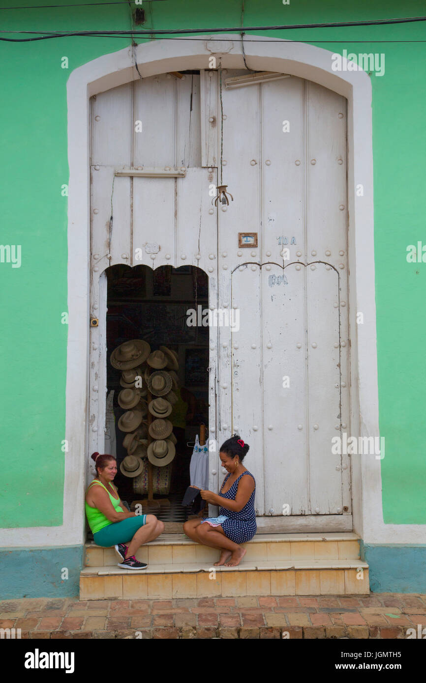 Local Women Seated in Doorway, Trinidad, UNESCO World Heritage Site, Sancti Spiritus, Cuba Stock Photo