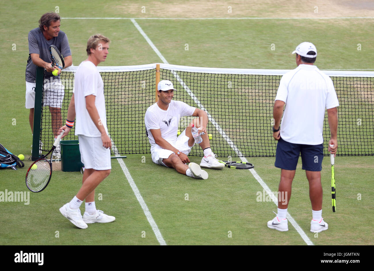 Spain's Rafael Nadal with his coaching team during a training session on day seven of the Wimbledon Championships at the All England Lawn Tennis and Croquet Club, Wimbledon. Stock Photo