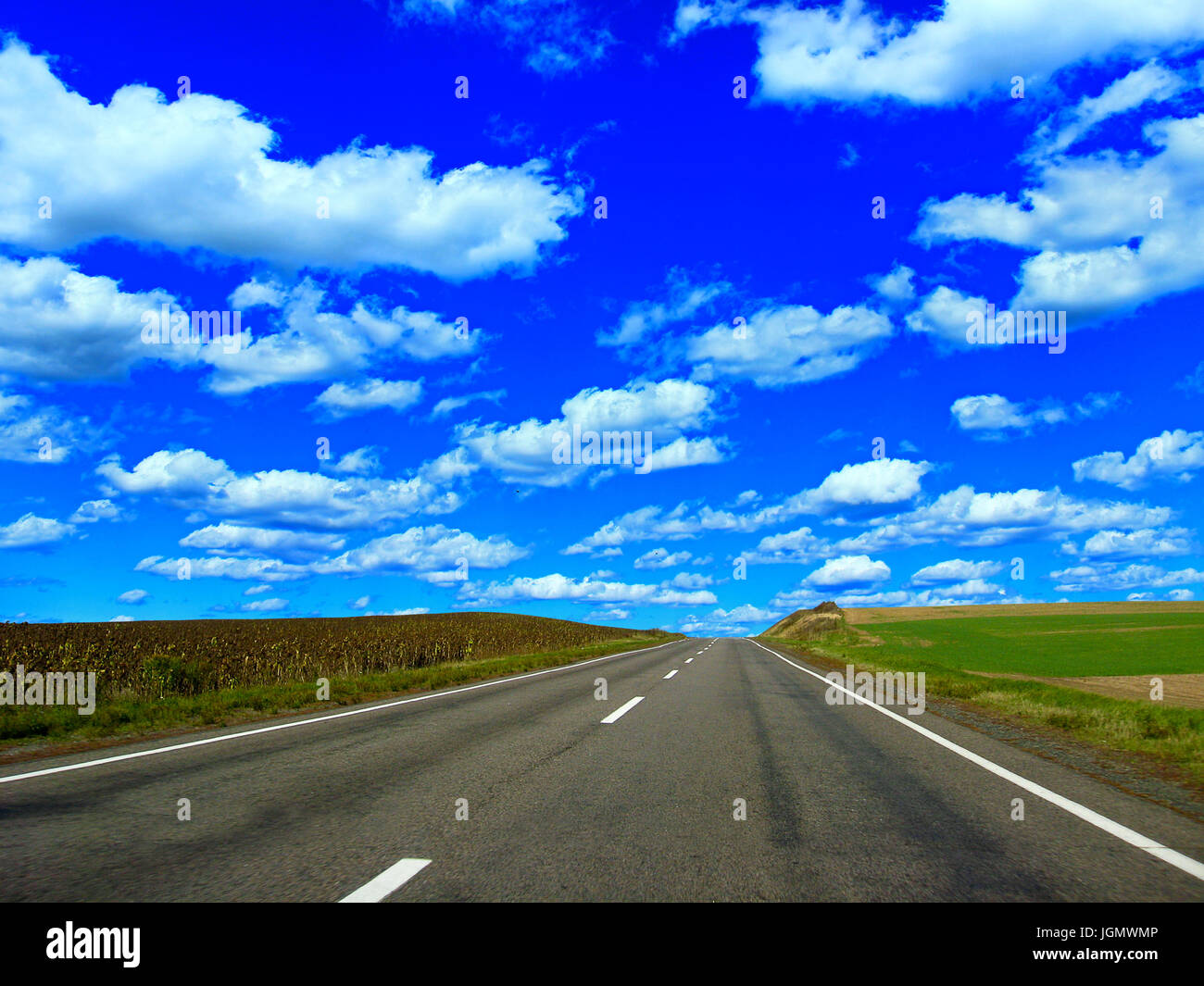 empty asphalted highway with blue sky and white clouds Stock Photo - Alamy