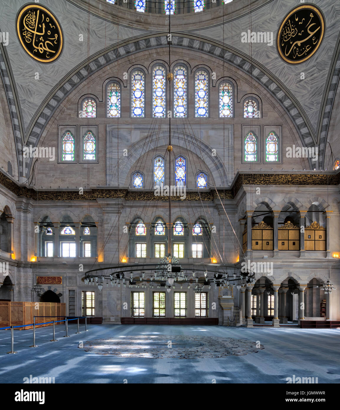 Interior facade of Nuruosmaniye Mosque, an Ottoman Baroque style mosque completed in 1755, with a huge arch & many colored stained glass windows locat Stock Photo