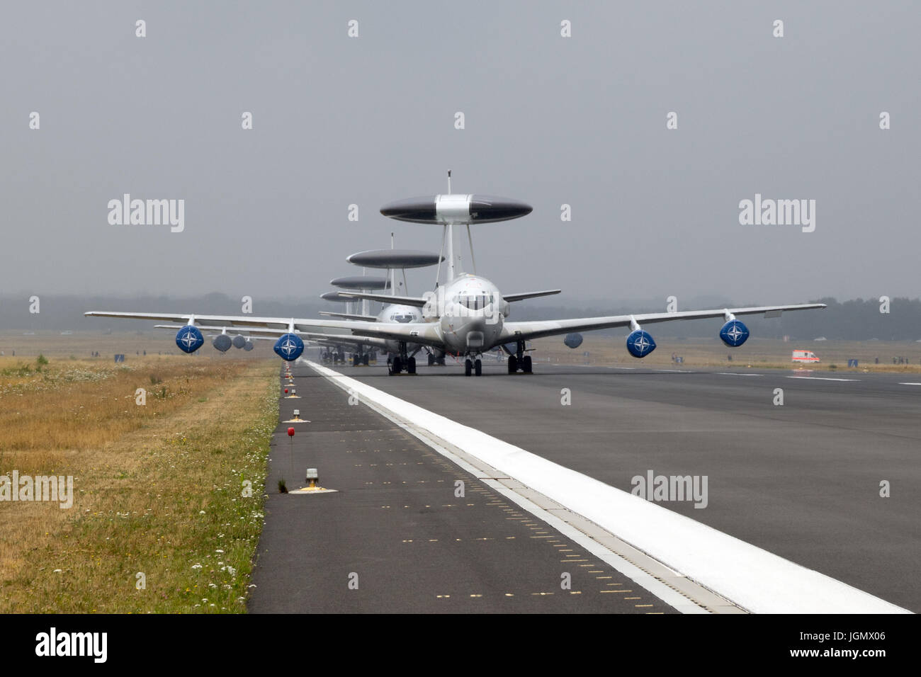 GEILENKIRCHEN, GERMANY - JUL 2, 2017: Row of NATO Boeing E-3 Sentry AWACS radar planes on the runway of Geilenkirchen airbase. Stock Photo