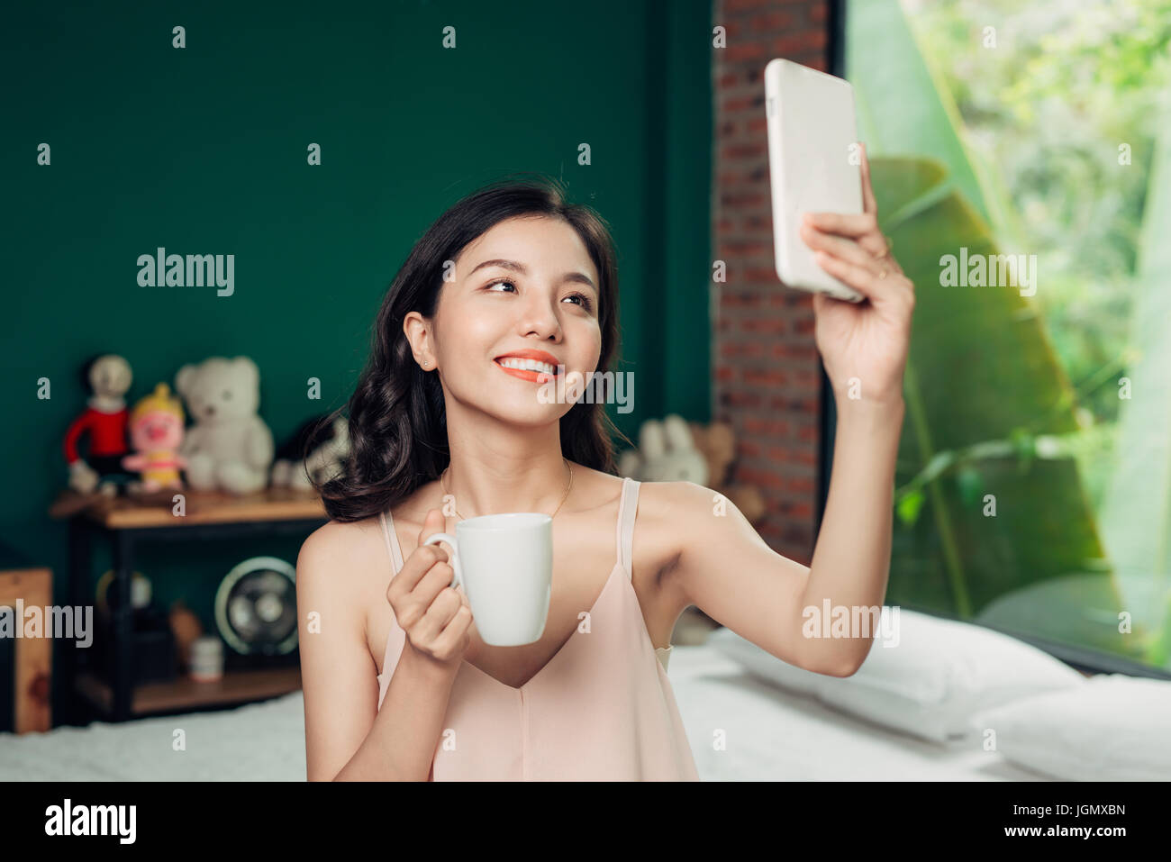 Health asian woman smile take a selfie and she sitting on the bed at home Stock Photo