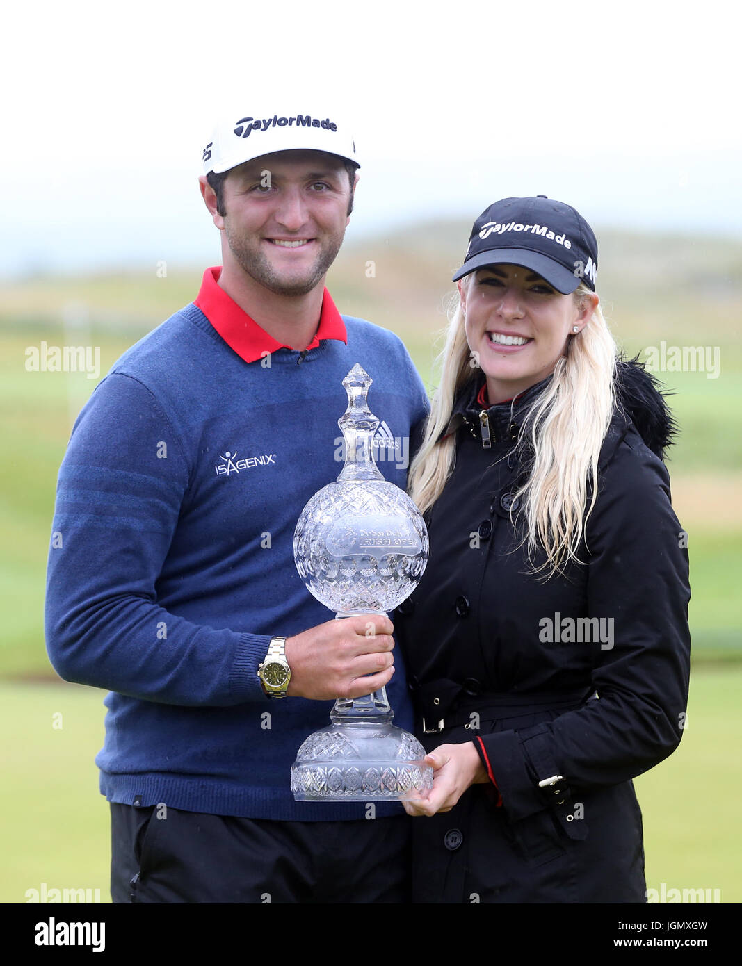 Spain's Jon Rahm celebrates winning the Dubai Duty Free Irish Open with girlfriend Kelley Cahill and the trophy at Portstewart Golf Club. Stock Photo
