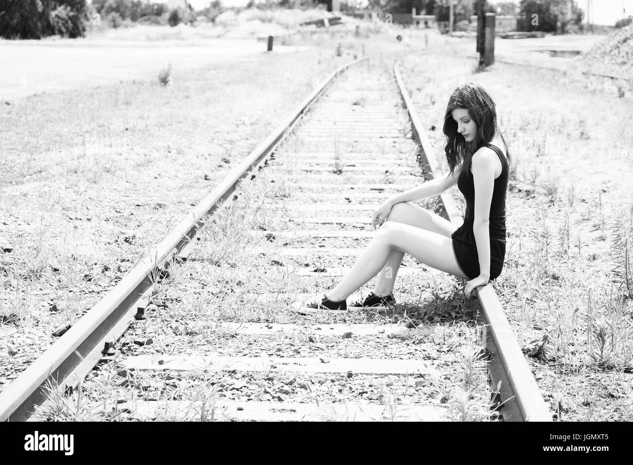 Sad teen girl at railway Stock Photo