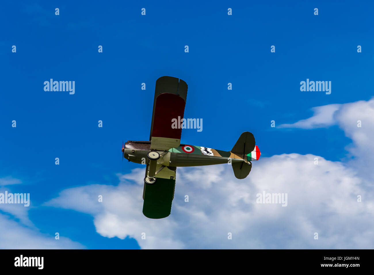 Flying biplane Spad S XIII replica from first world war between the clouds. Stock Photo