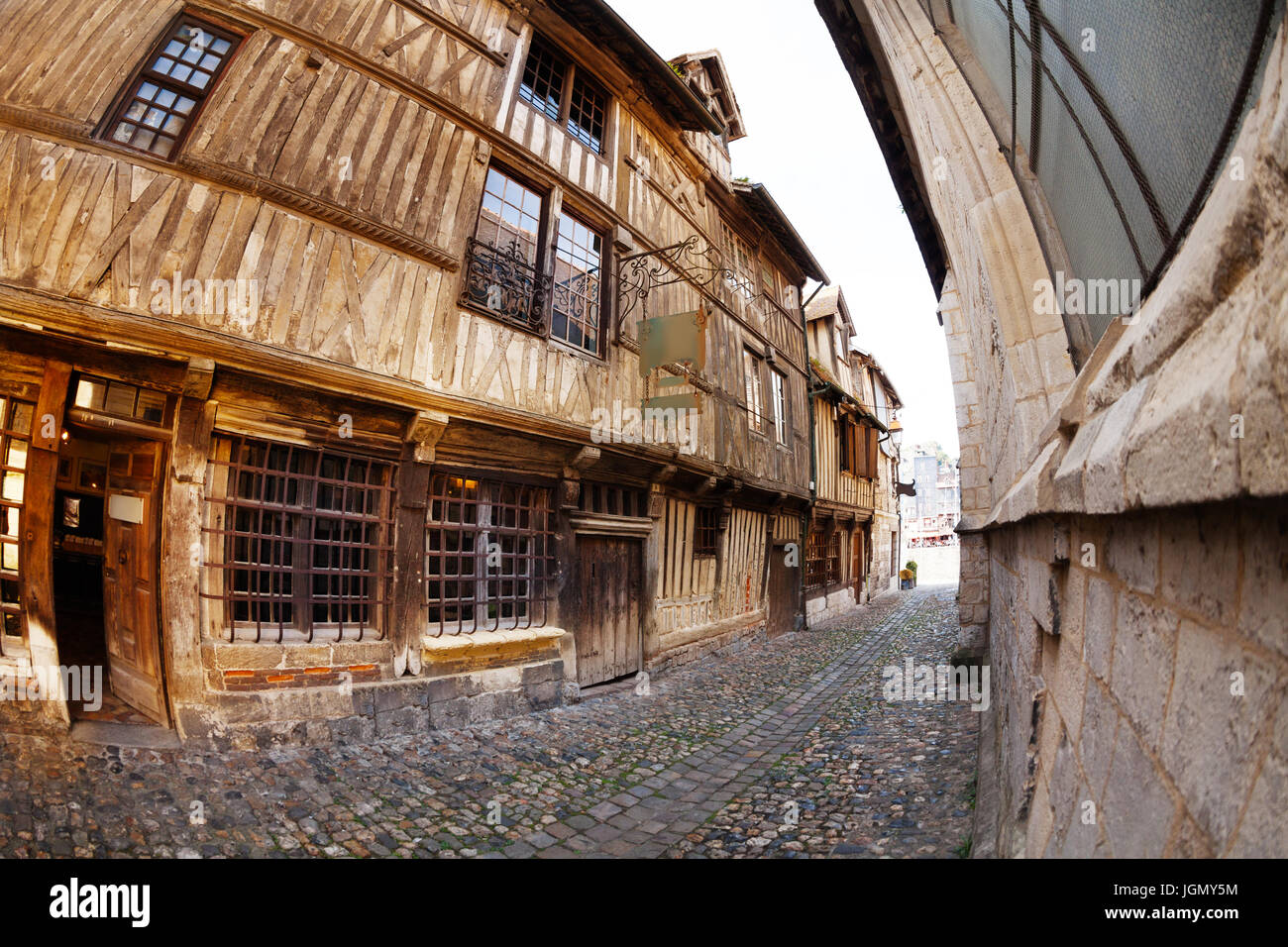 Narrow cobblestone paved street with old houses Stock Photo