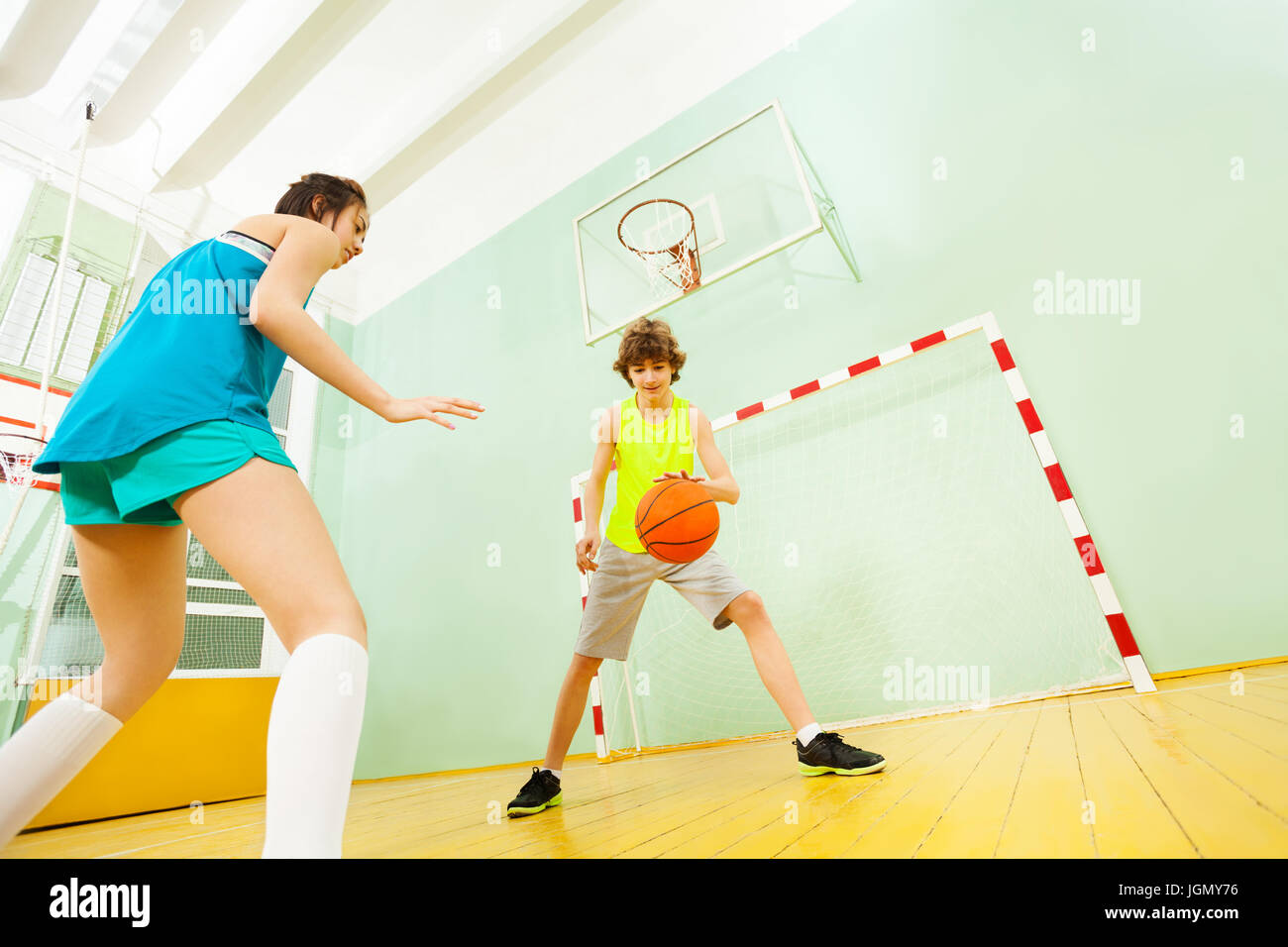 Teenage boy dribbling basketball during the match Stock Photo Alamy