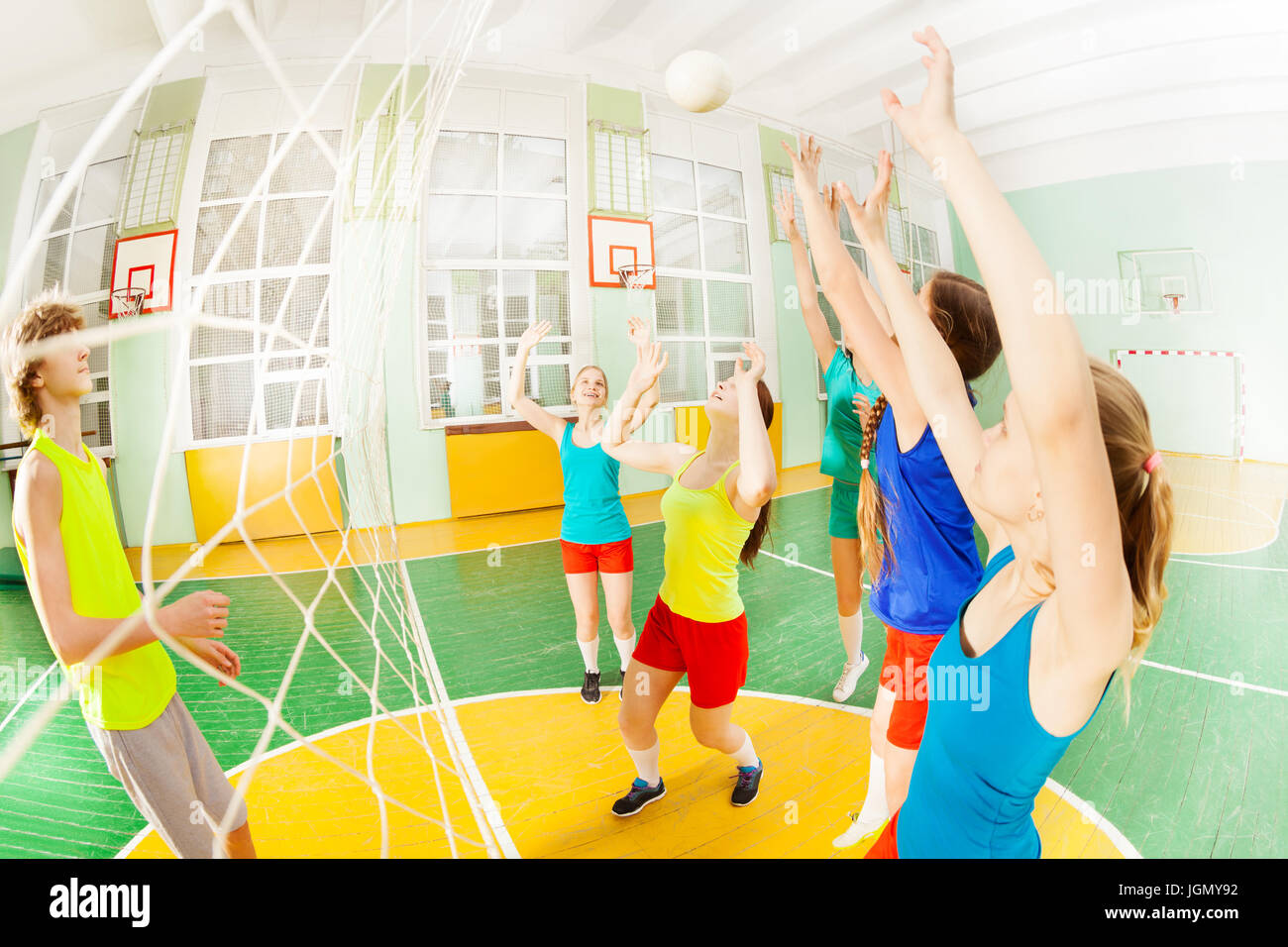 Volleyball game with group of teens in sports hall Stock Photo Alamy