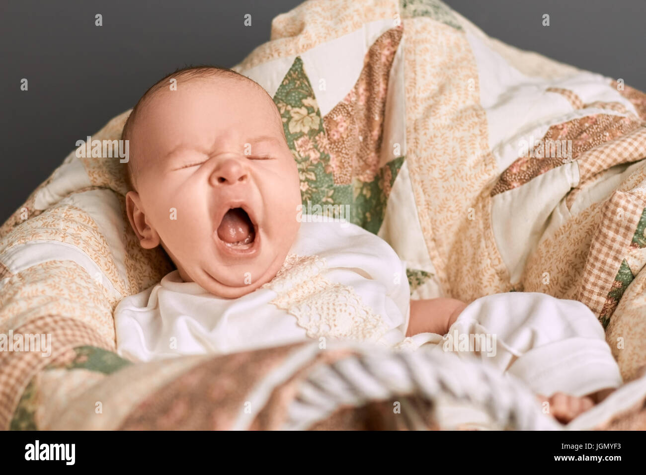 Yawn of an infant. Baby with mouth open. Facts about yawning. Stock Photo